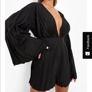 Boohoo. UK 16, US 12. Black romper with flare sleeves.